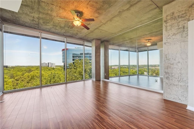 unfurnished sunroom with ceiling fan