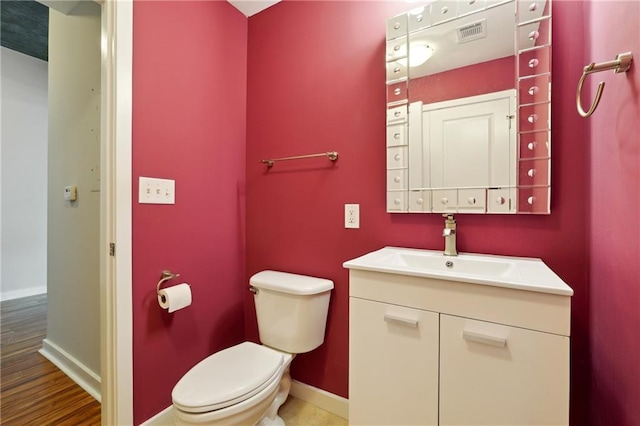 bathroom featuring hardwood / wood-style flooring, vanity, and toilet