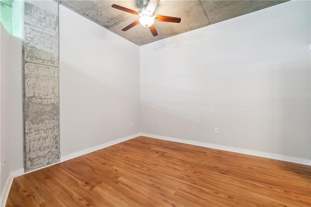 spare room featuring wood-type flooring and ceiling fan