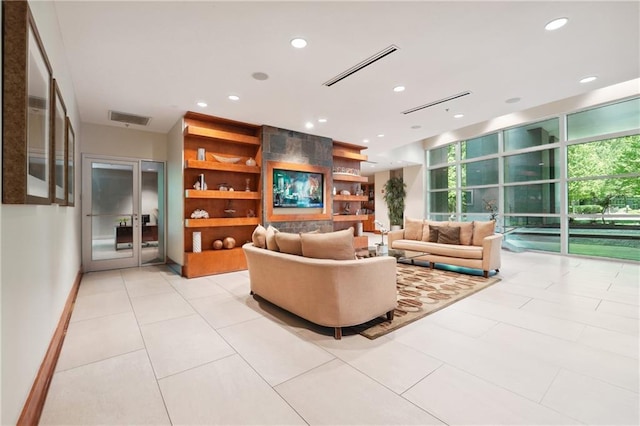 living room with light tile patterned floors and built in features