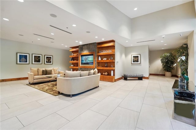 living room featuring a towering ceiling and light tile patterned floors