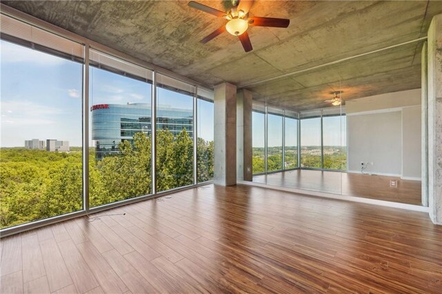 unfurnished sunroom with a wealth of natural light and ceiling fan