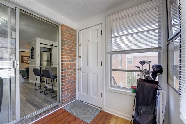 6700 Roswell Rd Unit 32C, Atlanta, GA 30328 - foyer entrance with wood finished floors, baseboards, and a textured ceiling