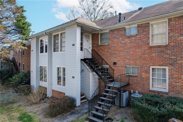 6700 Roswell Rd Unit 32C, Atlanta, GA 30328 - back of house with stairs, central AC unit, and brick siding