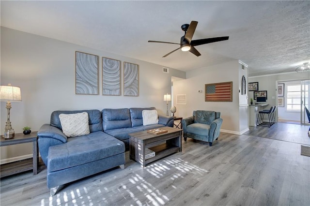 6700 Roswell Rd Unit 32C, Atlanta, GA 30328 - living room featuring wood finished floors, ceiling fan, baseboards, and a chandelier