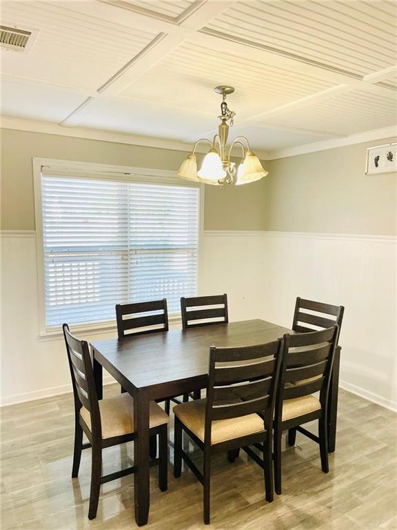 dining space featuring a chandelier and wood-type flooring