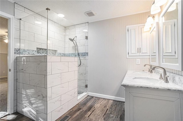 1488 White Columns Blvd, Canton, GA 30115 - bathroom featuring a stall shower, double vanity, wood finished floors, a textured ceiling, and crown molding