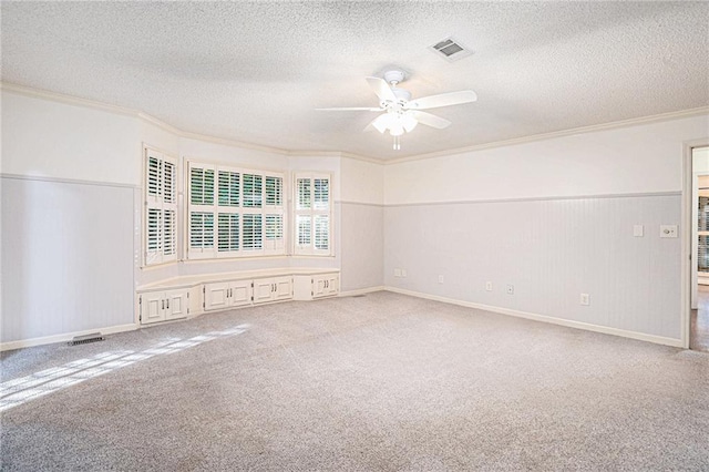 1488 White Columns Blvd, Canton, GA 30115 - spare room featuring ornamental molding, a ceiling fan, a textured ceiling, carpet, and a wainscoted wall