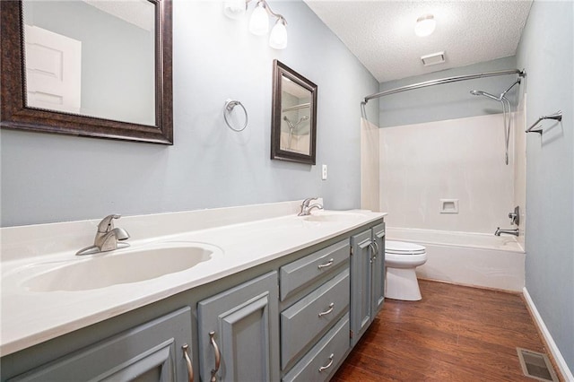 1488 White Columns Blvd, Canton, GA 30115 - bathroom with washtub / shower combination, double vanity, a textured ceiling, and wood finished floors
