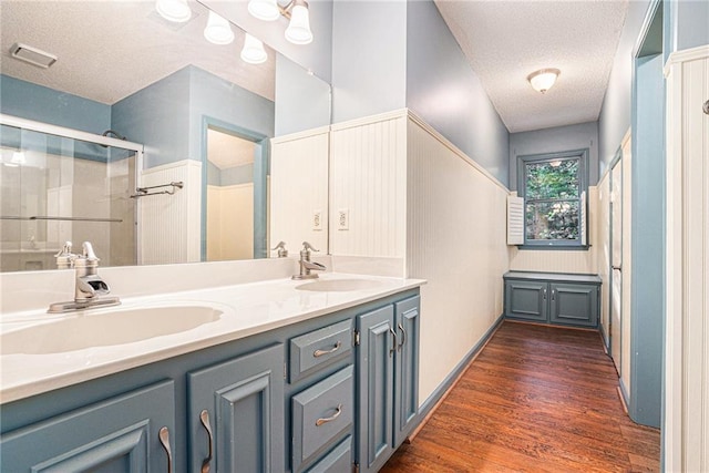 1488 White Columns Blvd, Canton, GA 30115 - full bath with a textured ceiling, double vanity, a shower with shower door, and wood finished floors