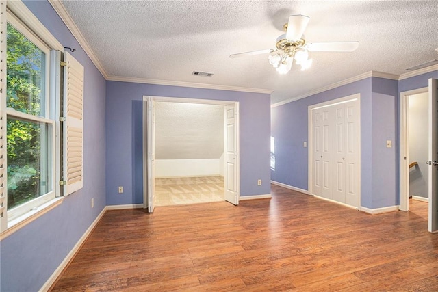 1488 White Columns Blvd, Canton, GA 30115 - spare room with wood finished floors, healthy amount of natural light, a textured ceiling, and ornamental molding