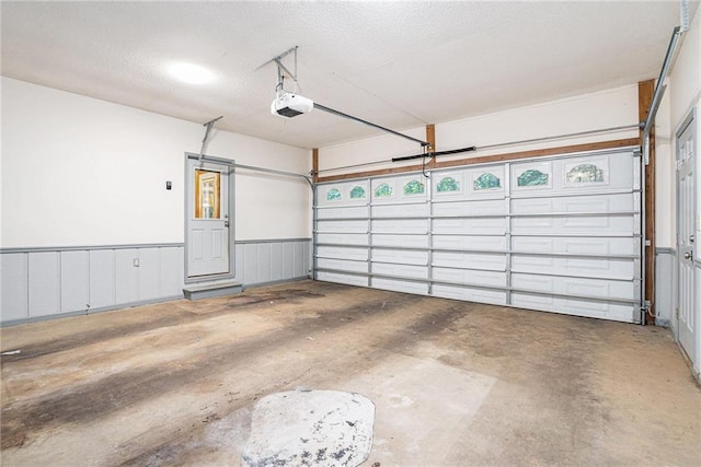 1488 White Columns Blvd, Canton, GA 30115 - garage featuring a garage door opener and wainscoting