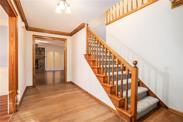 1488 White Columns Blvd, Canton, GA 30115 - stairs with wood finished floors, a textured ceiling, ornamental molding, and a fireplace