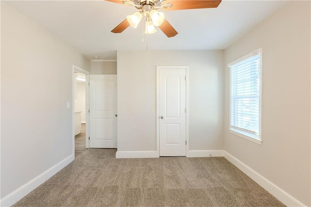 unfurnished bedroom with light carpet and ceiling fan