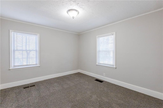 empty room featuring carpet floors, a textured ceiling, and ornamental molding