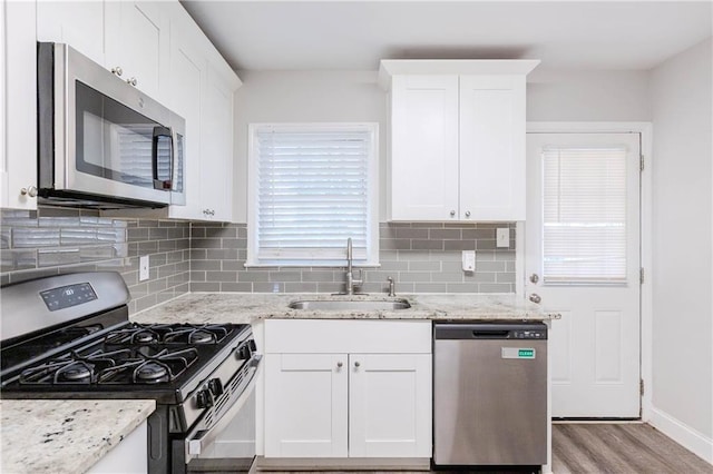 kitchen with white cabinets, stainless steel appliances, and sink