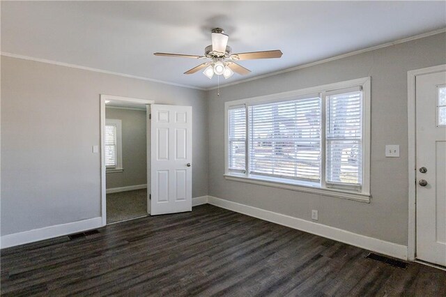 interior space with dark hardwood / wood-style floors, a wealth of natural light, crown molding, and ceiling fan