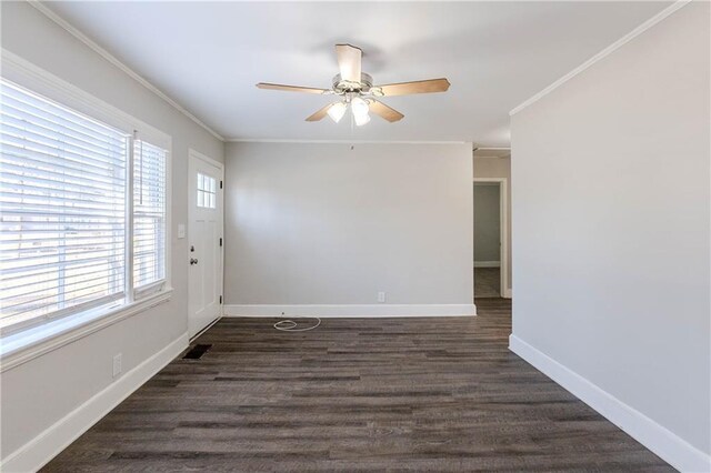 empty room with ceiling fan, dark hardwood / wood-style floors, and ornamental molding