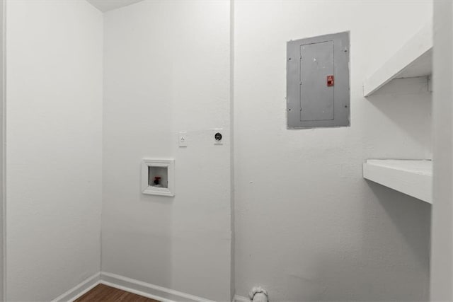 washroom with hookup for a washing machine, electric panel, and dark hardwood / wood-style flooring