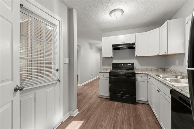 kitchen with black appliances, white cabinets, a textured ceiling, and dark hardwood / wood-style flooring