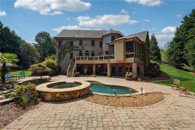 view of swimming pool with an in ground hot tub, a deck, and a patio area