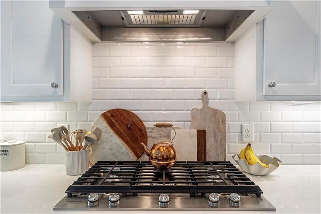 kitchen with custom range hood, light countertops, tasteful backsplash, and stainless steel gas stovetop