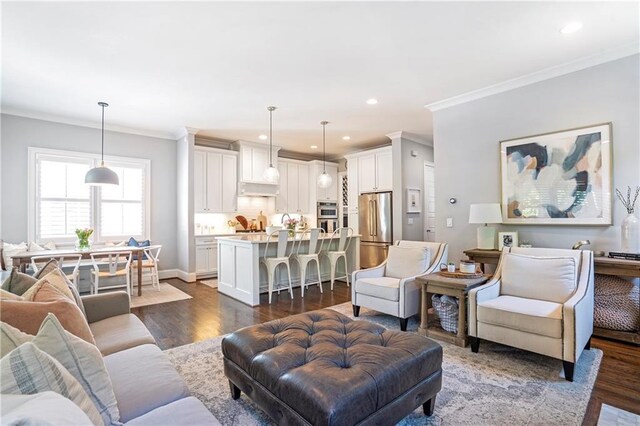 living room featuring recessed lighting, ornamental molding, and dark wood-style floors