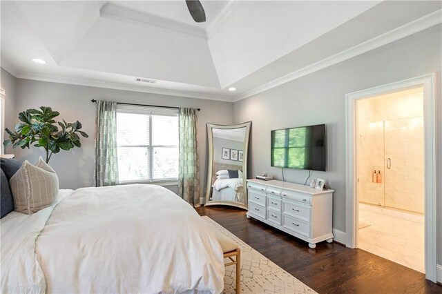 bedroom with visible vents, recessed lighting, dark wood-type flooring, a raised ceiling, and ensuite bath