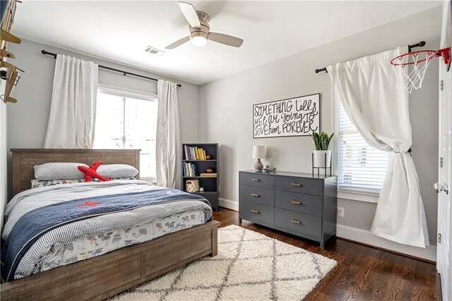bedroom with baseboards, multiple windows, and visible vents