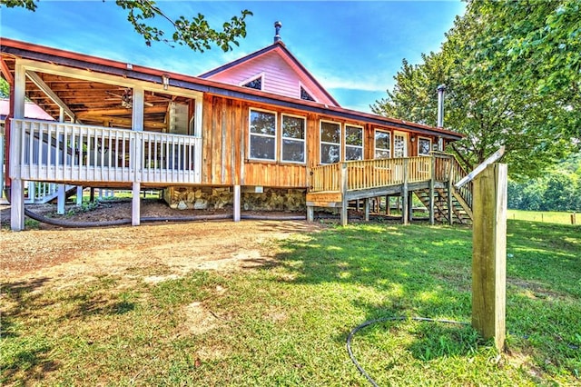 back of property featuring a lawn and a deck