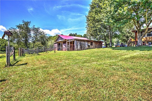 view of yard with a rural view and an outdoor structure