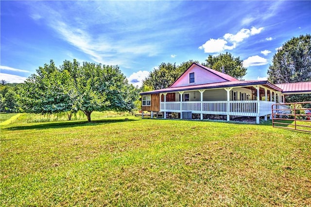 rear view of house featuring a yard