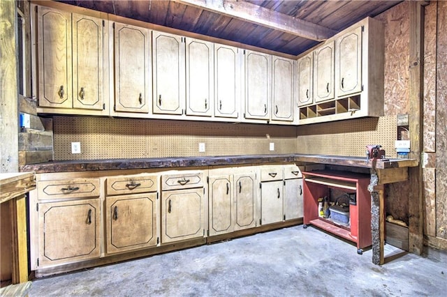 kitchen featuring dark countertops, wood ceiling, and unfinished concrete floors