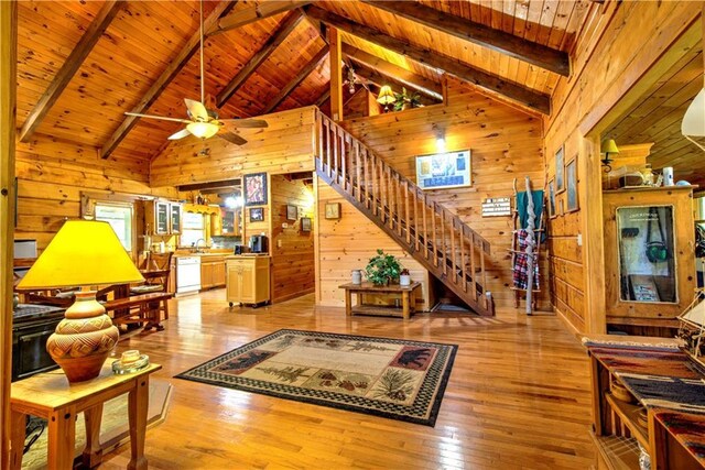 living room with wood ceiling, wood walls, and light wood-type flooring