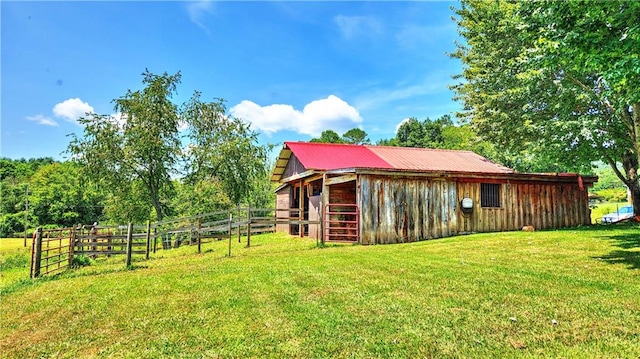 view of yard with a rural view and an outbuilding