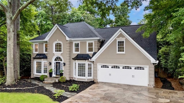 910 Kings Arms Way, Johns Creek, GA 30022 - view of front of property featuring driveway, stucco siding, a shingled roof, and a garage
