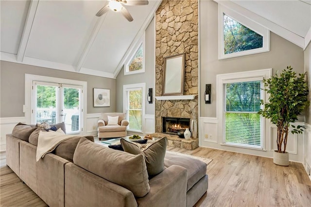 910 Kings Arms Way, Johns Creek, GA 30022 - living area featuring light wood-style flooring, beam ceiling, a wainscoted wall, a decorative wall, and a fireplace
