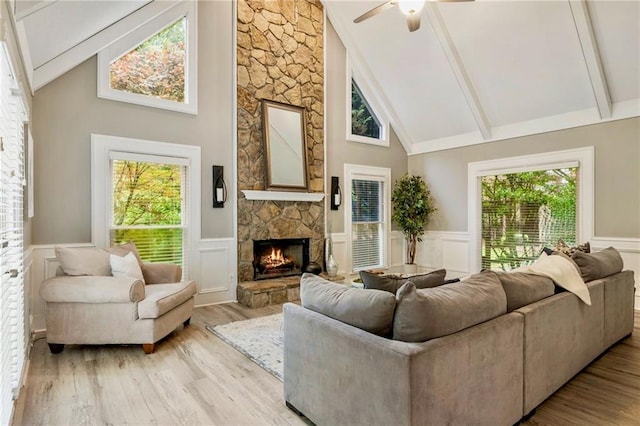 910 Kings Arms Way, Johns Creek, GA 30022 - living area featuring high vaulted ceiling, a stone fireplace, a wainscoted wall, beam ceiling, and wood finished floors