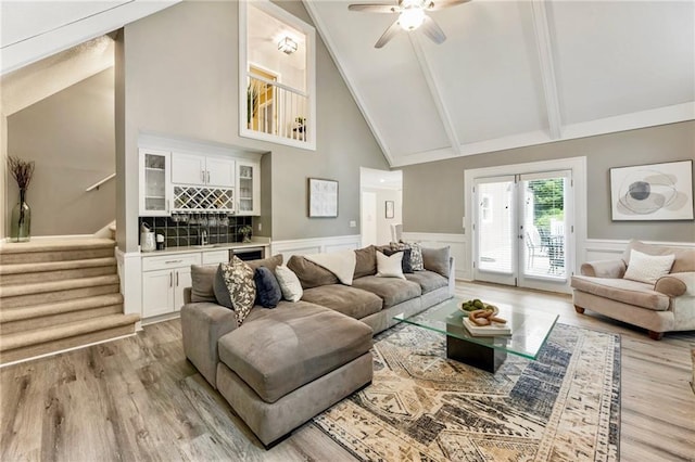 910 Kings Arms Way, Johns Creek, GA 30022 - living room featuring light wood-type flooring, stairway, high vaulted ceiling, a dry bar, and a ceiling fan