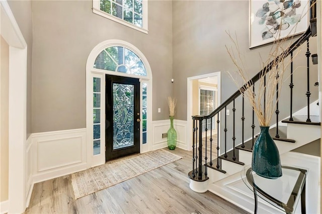910 Kings Arms Way, Johns Creek, GA 30022 - foyer entrance with wainscoting, stairs, wood finished floors, a decorative wall, and a towering ceiling