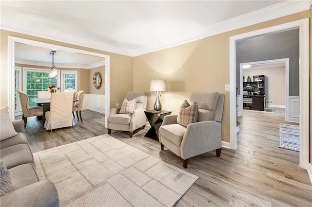 910 Kings Arms Way, Johns Creek, GA 30022 - living room with light wood finished floors, crown molding, wainscoting, and a decorative wall
