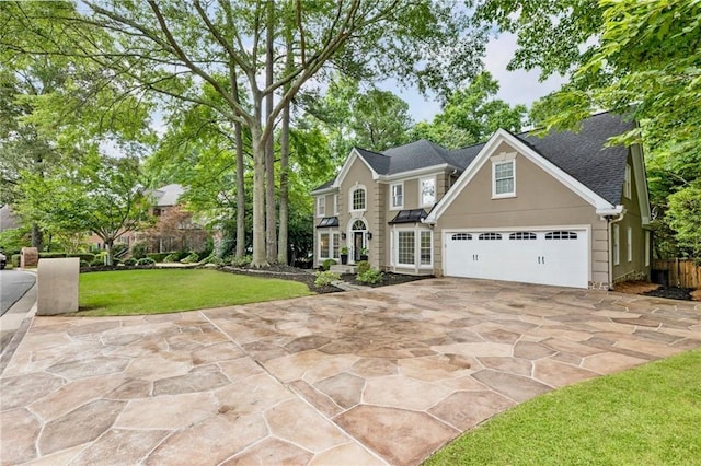 910 Kings Arms Way, Johns Creek, GA 30022 - view of front facade featuring driveway, a front lawn, stucco siding, and a shingled roof