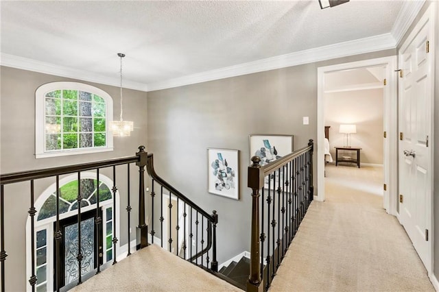 910 Kings Arms Way, Johns Creek, GA 30022 - hallway with an upstairs landing, a chandelier, carpet, and crown molding