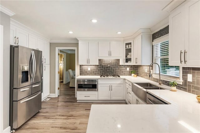 910 Kings Arms Way, Johns Creek, GA 30022 - kitchen featuring appliances with stainless steel finishes, crown molding, white cabinetry, backsplash, and recessed lighting