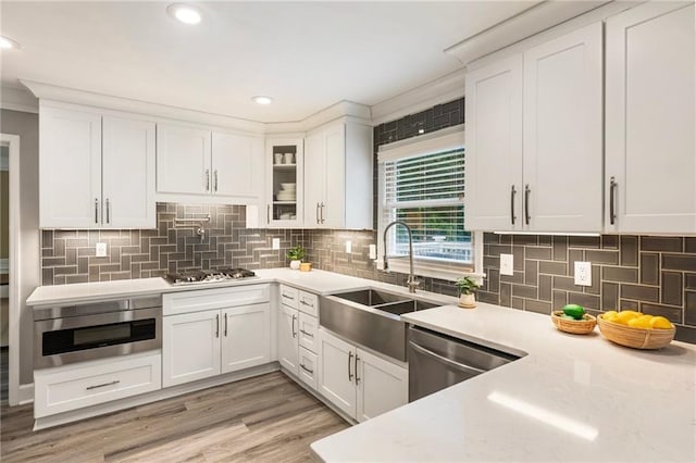 910 Kings Arms Way, Johns Creek, GA 30022 - kitchen featuring appliances with stainless steel finishes, white cabinetry, tasteful backsplash, glass insert cabinets, and recessed lighting