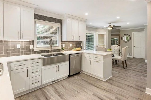 910 Kings Arms Way, Johns Creek, GA 30022 - kitchen with stainless steel dishwasher, ornamental molding, a peninsula, light wood-style floors, and backsplash