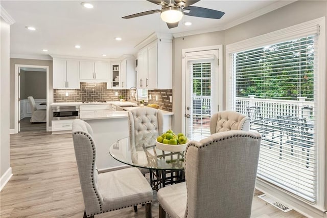 910 Kings Arms Way, Johns Creek, GA 30022 - dining area featuring crown molding, ceiling fan, light wood-style floors, and recessed lighting
