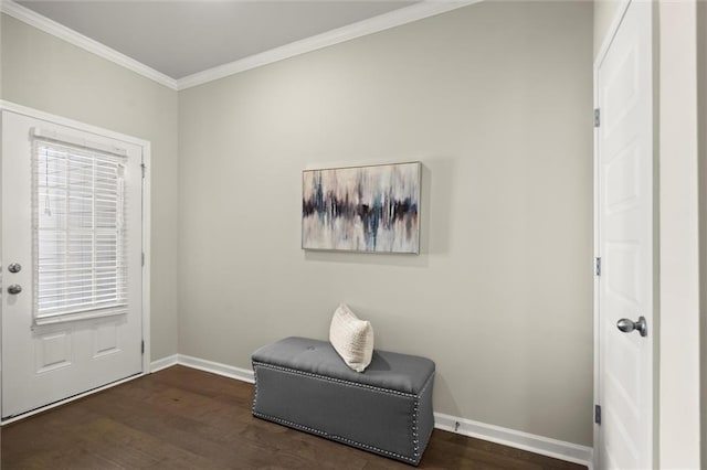 foyer with dark wood-style flooring, crown molding, and baseboards