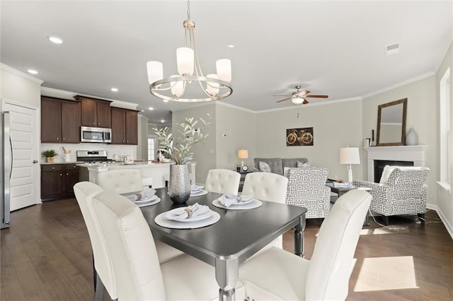 dining area with dark wood-style floors, a fireplace, crown molding, and recessed lighting