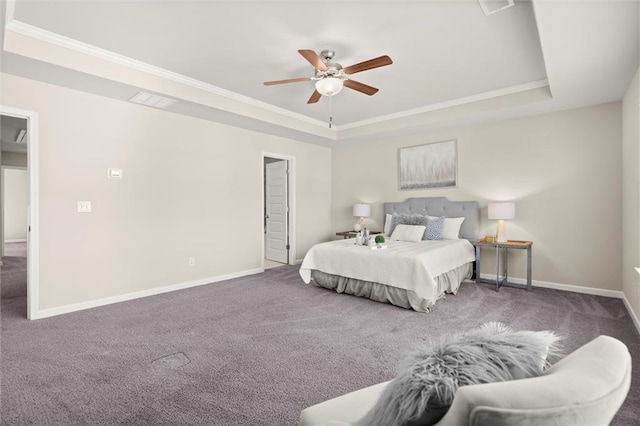 bedroom featuring a tray ceiling, baseboards, and dark colored carpet